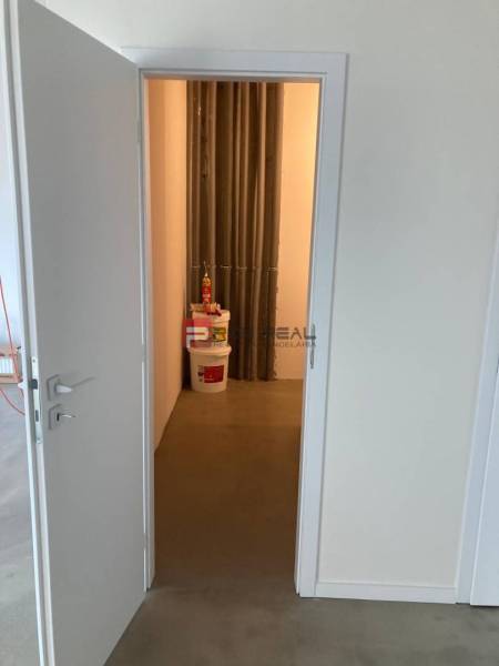 Open door leading to storage space in commercial premises.