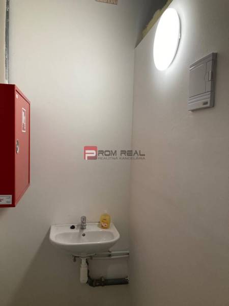 Break with light, sink, and fire extinguisher in commercial premises.