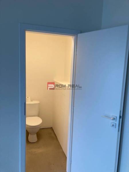 Restroom in commercial premises with a simple and clean design.