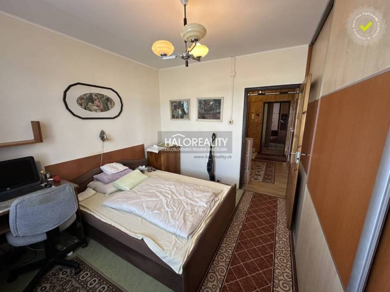 Bedroom in a 3-room apartment with a built-in wardrobe, computer desk, and wall decoration.