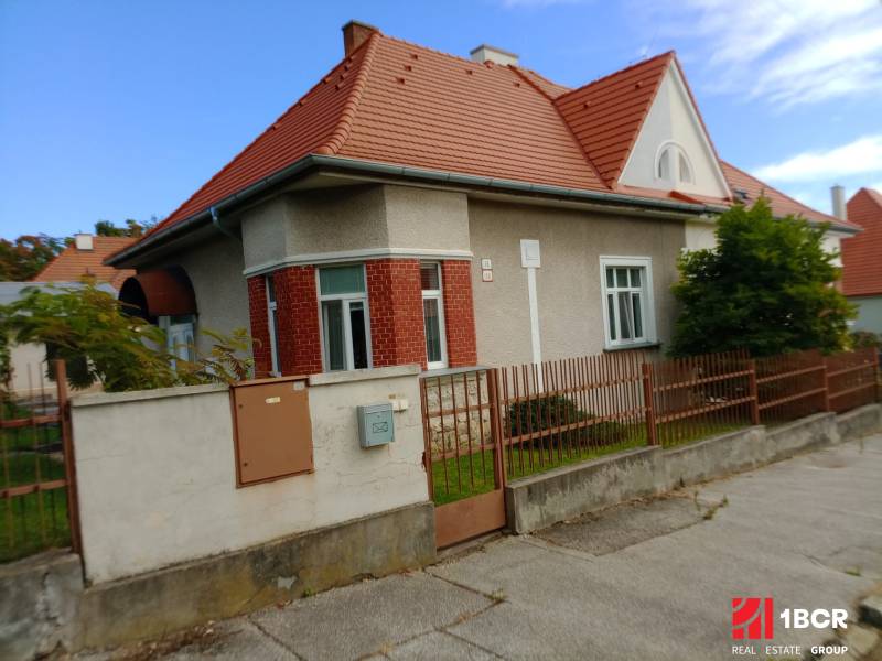 A family house on Nécseyho Street in Nitra with a red roof and brick facade.
