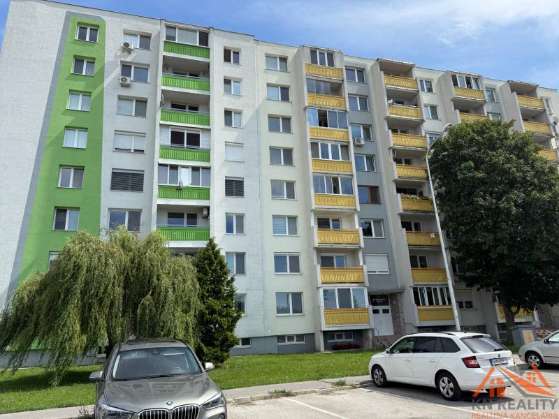 Apartment building on Železiarenská Street in Galanta with parked cars and greenery.