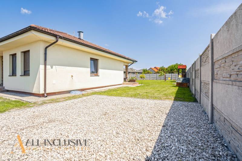A family house in Čečínska Potôň in Horná Potôň with a lawn and fencing.