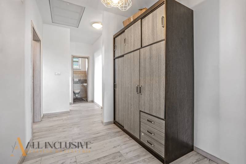 A hallway in a family house with a closet and an entrance to the toilet.