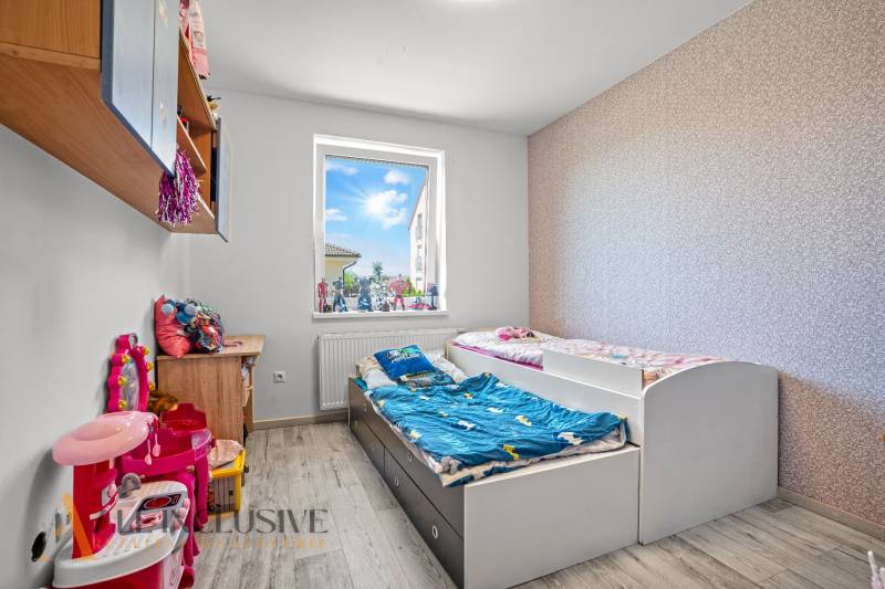 Children's room with two beds and toys in a family house.