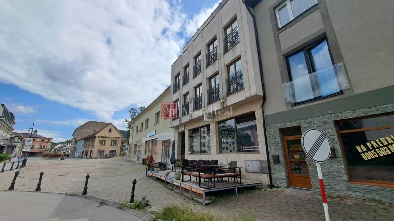 The building on Mostová Street in Ružomberok with a terrace and surrounding historical structures.