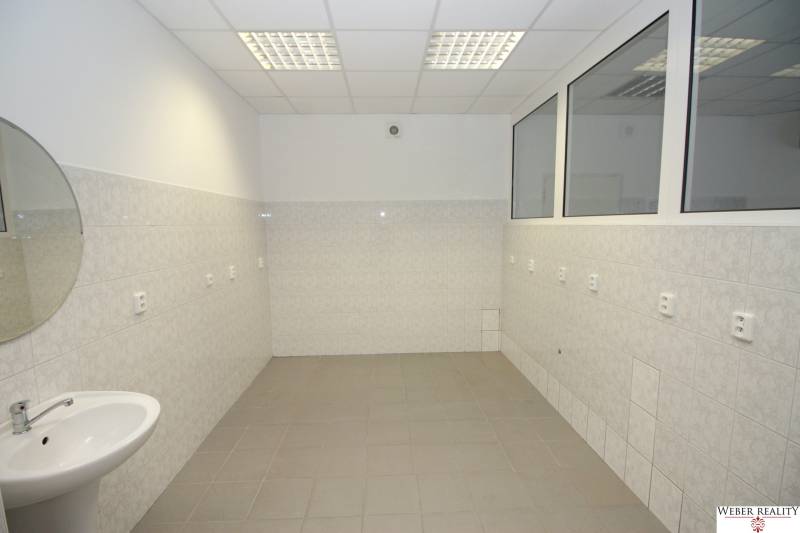 A bathroom with a sink and tiles in commercial premises.