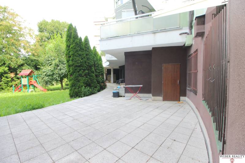 Terrace of commercial premises on Žatevná Street in Bratislava - Dúbravka, with a children's playground.