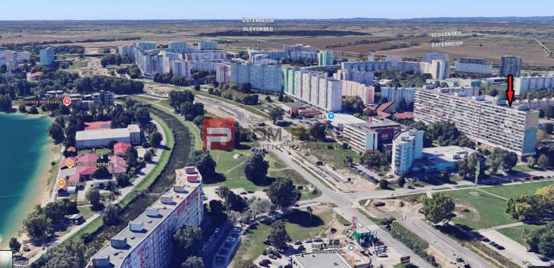 Aerial view of residential blocks on Strečnianska Street in Bratislava V with a pond.