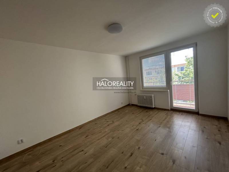A spacious room with a large window and balcony doors in a 3-room apartment.