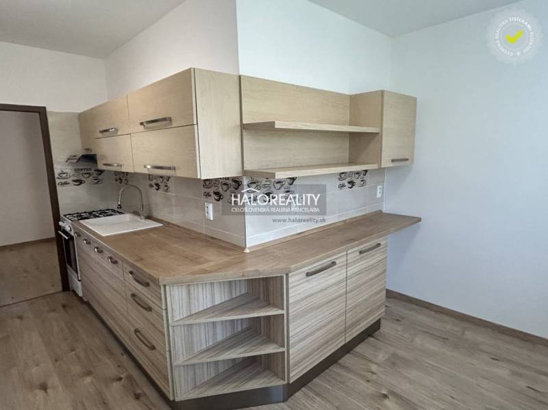 A kitchen with light wood and decor in a 3-room apartment.