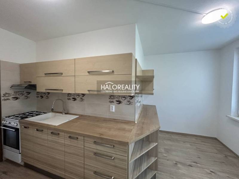 A kitchen in a 3-room apartment with wooden cabinets and equipment.