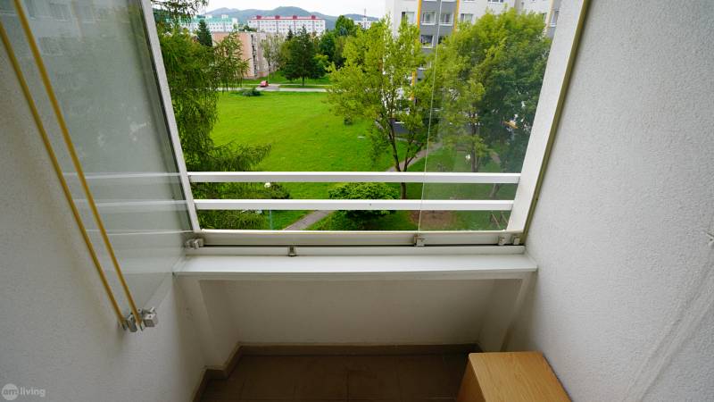 A balcony with a view of greenery and objects in Nova Dubnica, ideal for a 2-room apartment.