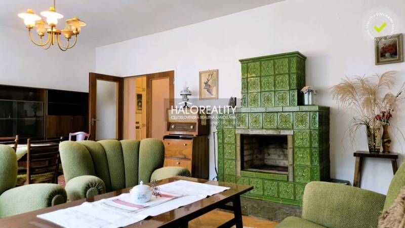 Living room with green tiles and retro furniture in a family house.