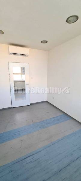 Office with air conditioning, doors, and a window with a radiator.