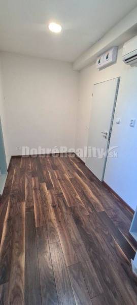 Offices with wooden flooring, white walls, and air conditioning.