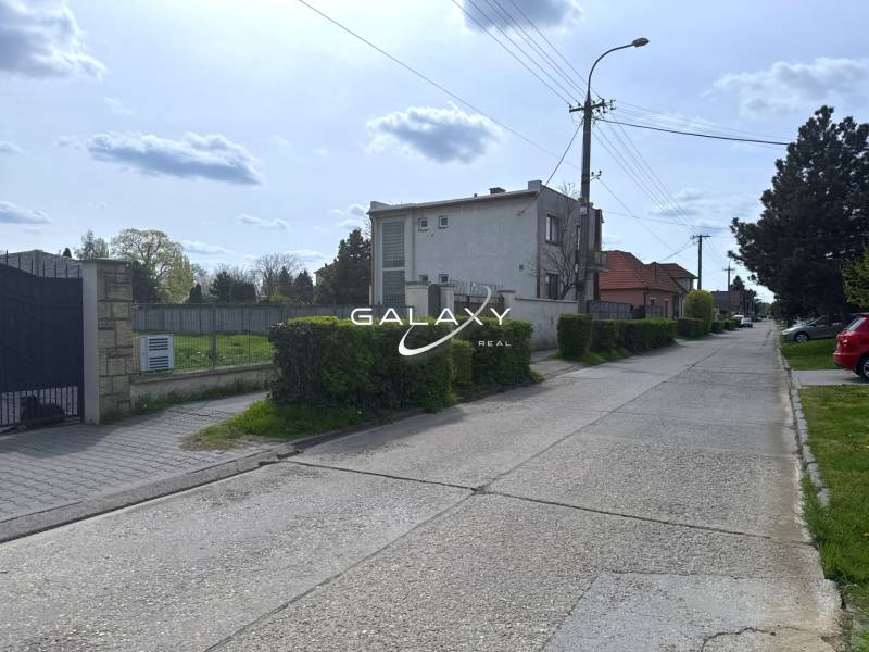 A peaceful street with greenery suitable for residential plots in Sládkovičovo.