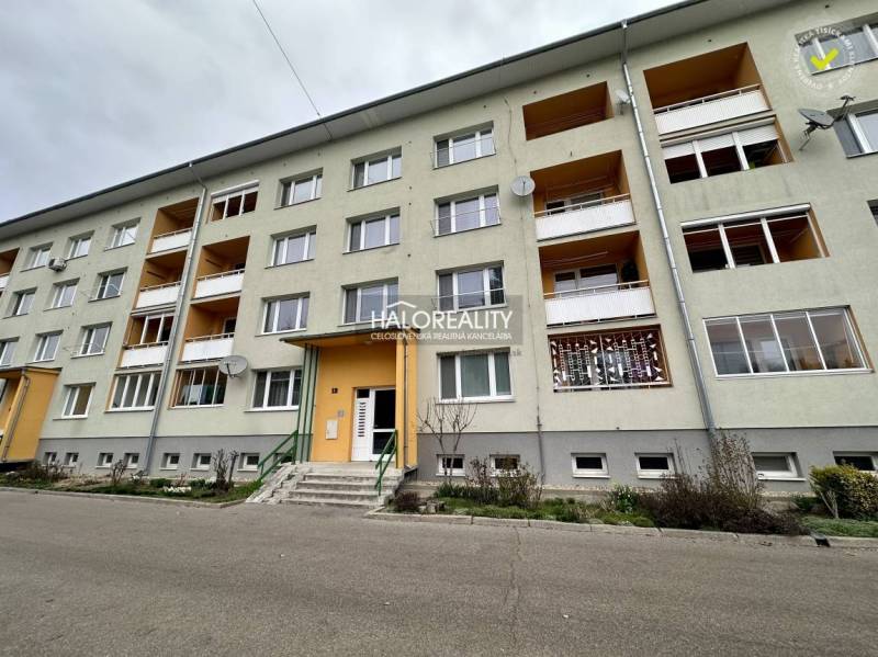 Apartment building in Rimavská Sobota with an entrance gate and balconies.