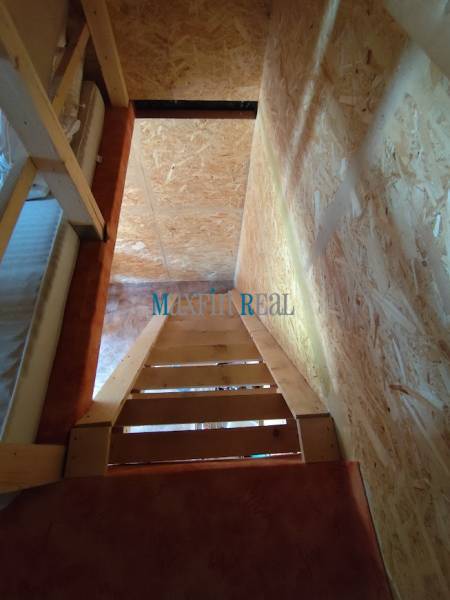 A staircase with wooden elements in a space suitable for plots - living.