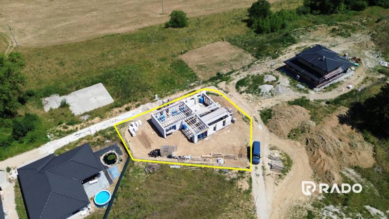Construction of a family house in Trenčianske Jastrabie, surrounded by nature and other buildings.