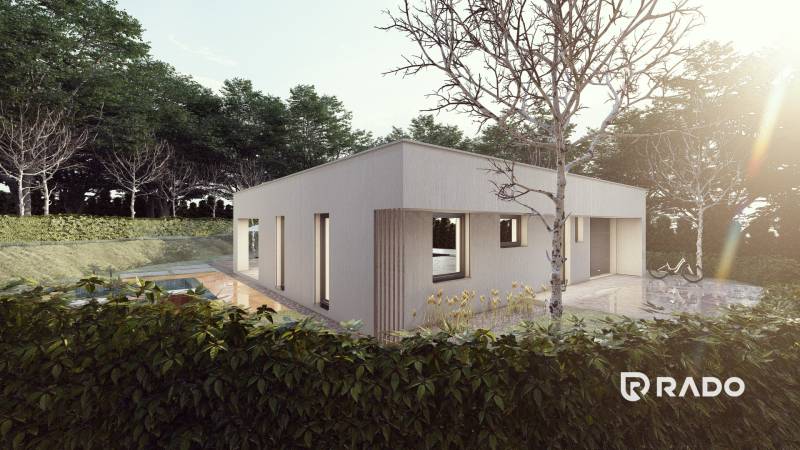 The family house in Trenčianske Jastrabie is surrounded by greenery, with a bicycle in front of it.