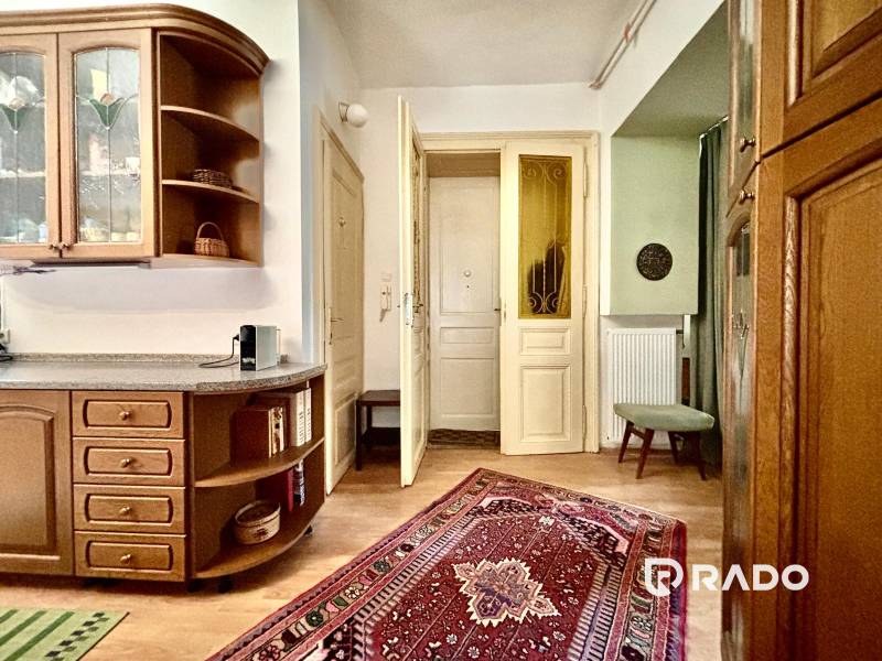 A kitchen corner with wooden furniture in a 2-room apartment, decorated with an oriental rug.