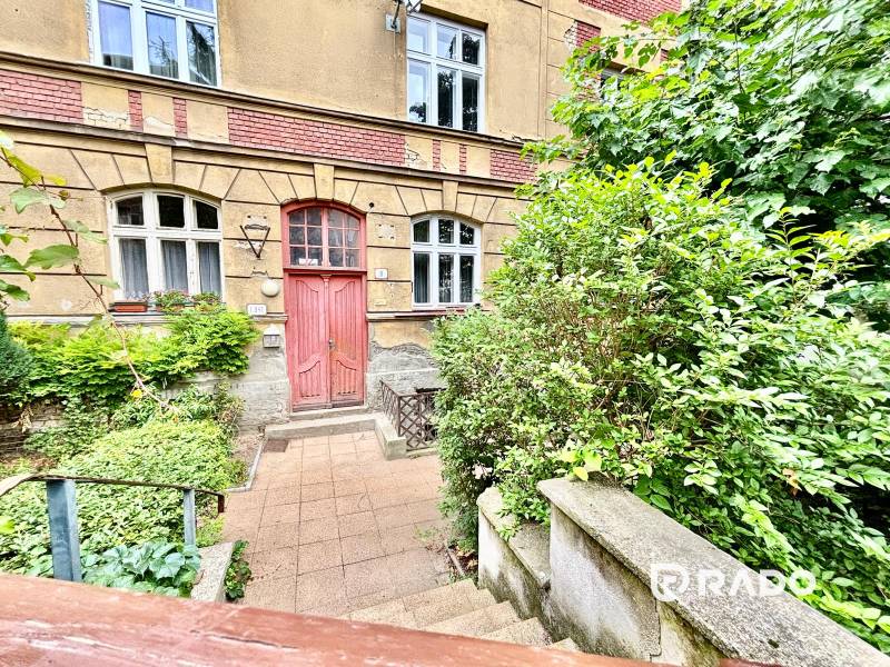 A historical building on Flöglova Street in Bratislava - Old Town, surrounded by greenery.