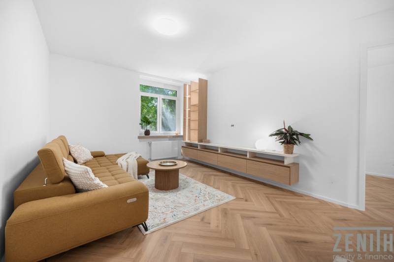 Living room in a 3-room apartment with a sofa, coffee table, and wooden floor.