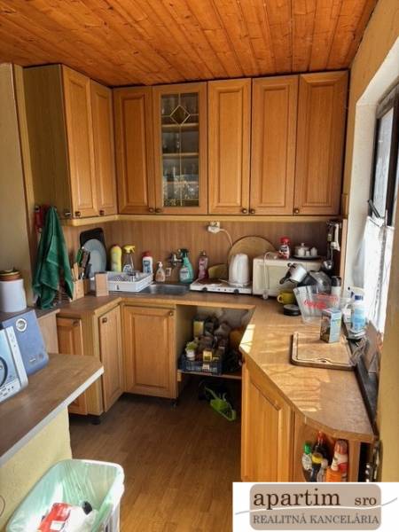 Kitchen unit with wooden cabinets full of kitchen utensils, suitable for Properties - living.
