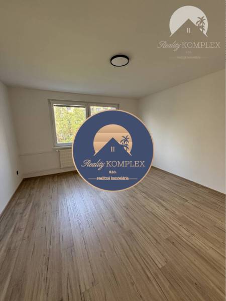 A spacious room with a wooden floor and a window in a 3-room apartment.