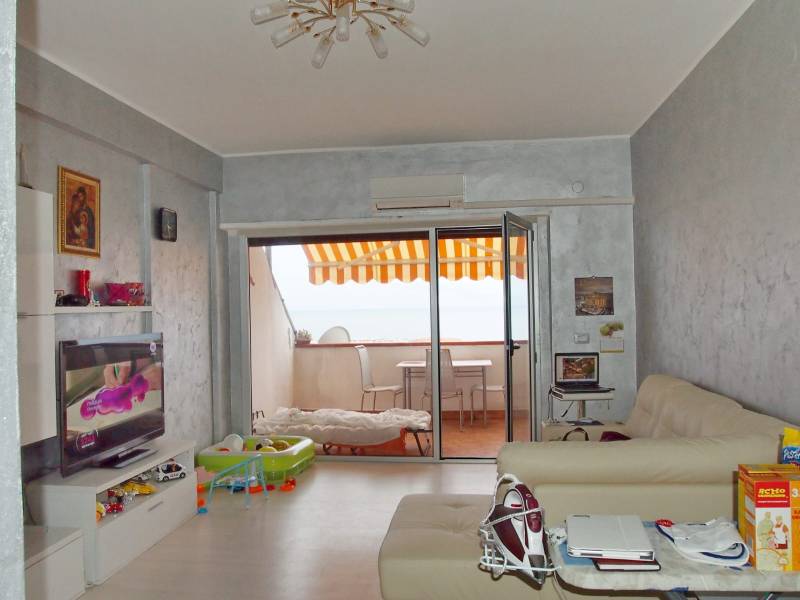 Living room in a 3-room apartment with a terrace, television, and comfortable sofas.