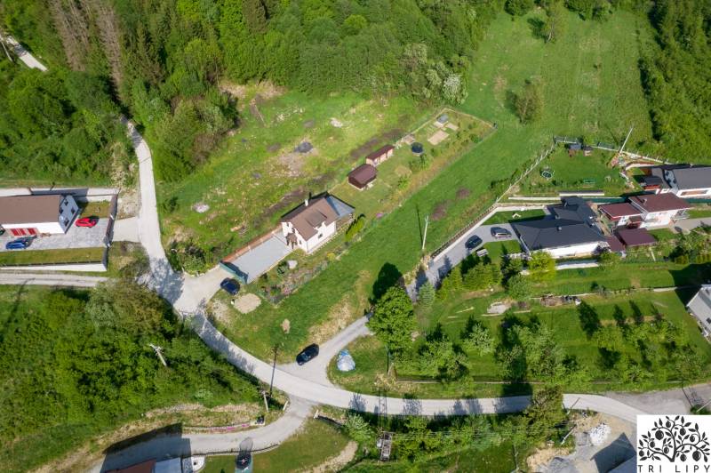 Aerial view of plots - housing in the town of Raková surrounded by greenery and roads.