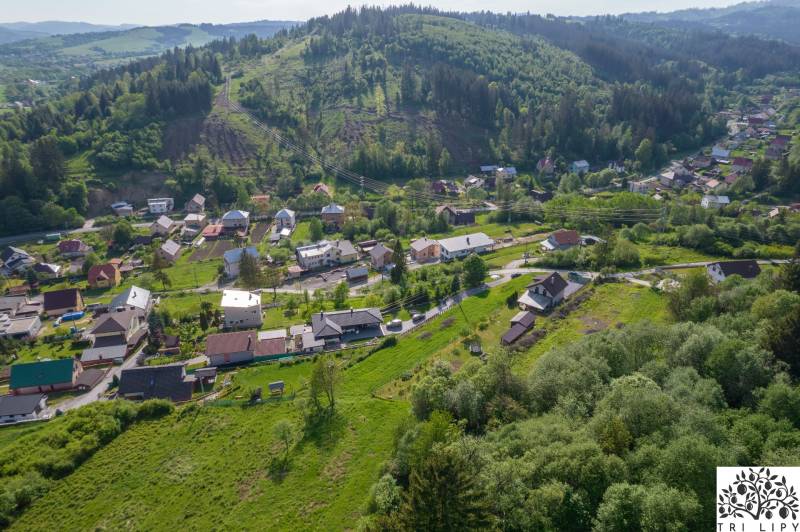 Aerial view of residential plots in Rakov surrounded by greenery and hills.