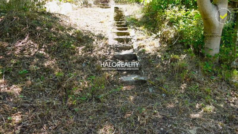 Stone steps leading up the slope, surrounded by greenery in the location Pozemky - bývanie, Pernek.