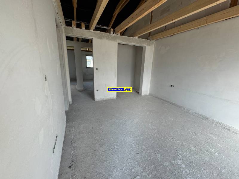 The interior of a family house with unfinished ceilings and incomplete walls.