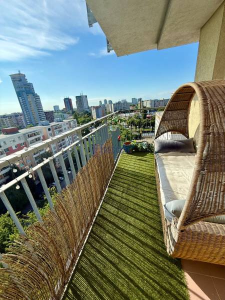 A balcony with comfortable seating in a 2-room apartment on Jégého Street in Bratislava - Ružinov.