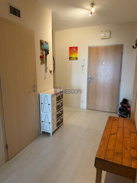 Entrance hall with a wardrobe and a wooden table in a 2-room apartment.