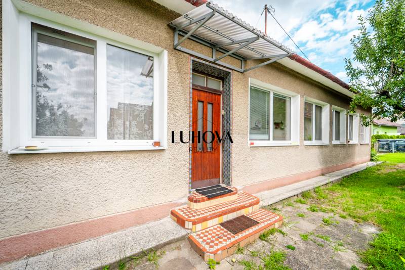 A family house on Pavla Koyša Street in Ladce with white windows and doors.