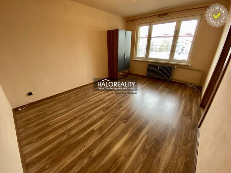 A room with a floor, a wardrobe, and a window offers a bright spatial solution for a studio apartment.