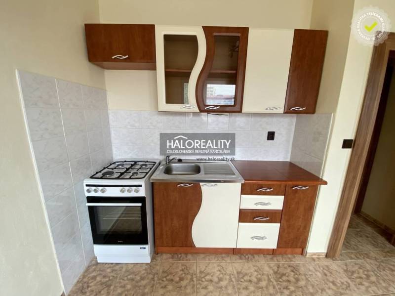 A small kitchen with a gas stove and a kitchenette in a studio apartment; rustic design.