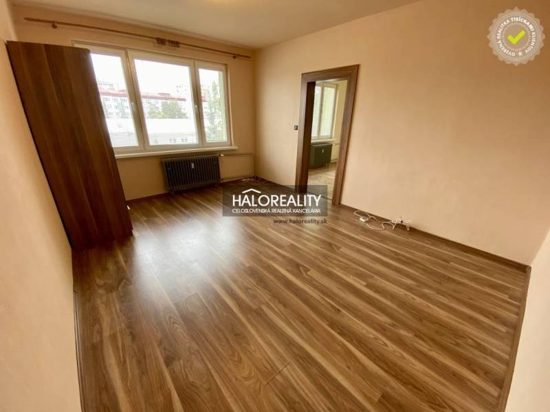 Interior of an empty room, floor in a studio apartment, and a window with a view.