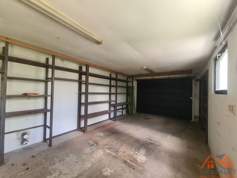 Garage with shelves and a gate in a family house.