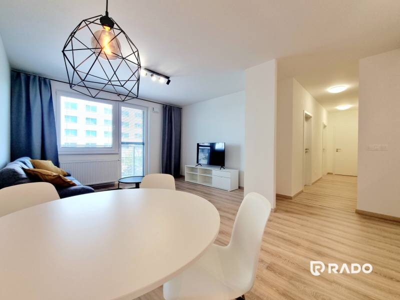 Living room with dining area and geometric lamp in a 3-room apartment.