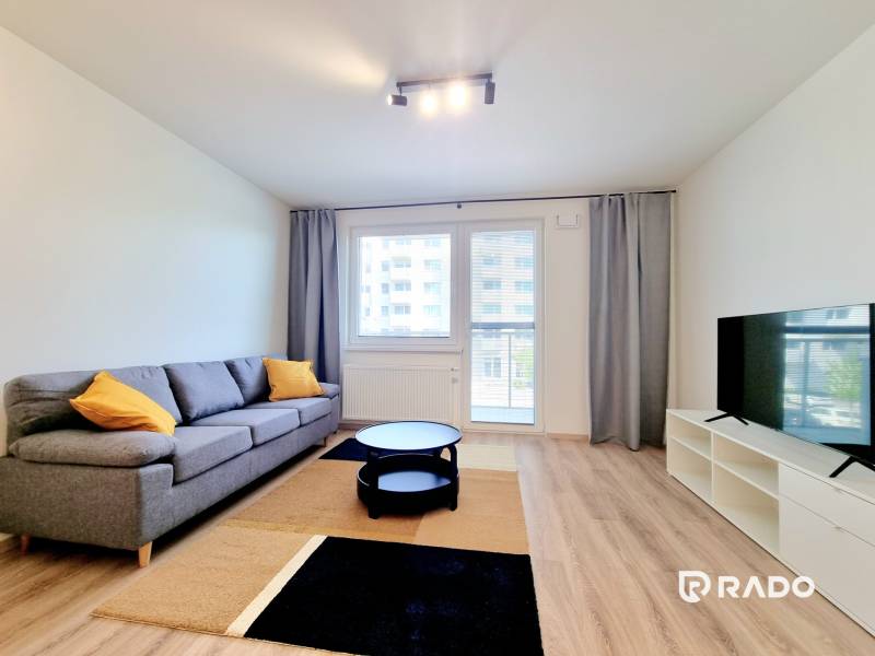 Living room with a sofa and a television in a 3-room apartment.