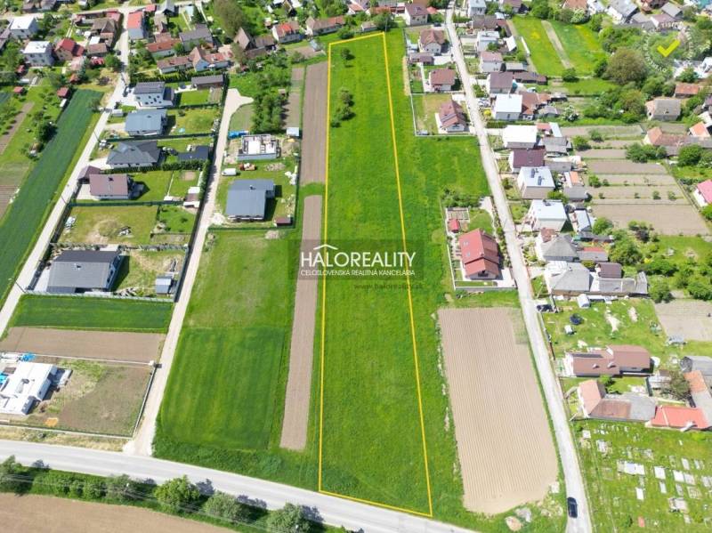 Aerial view of residential plots in Udiča, surrounded by houses and greenery.