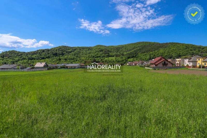 Greenery and panorama in Udiča, plots - housing with houses and wooded hills in the background.
