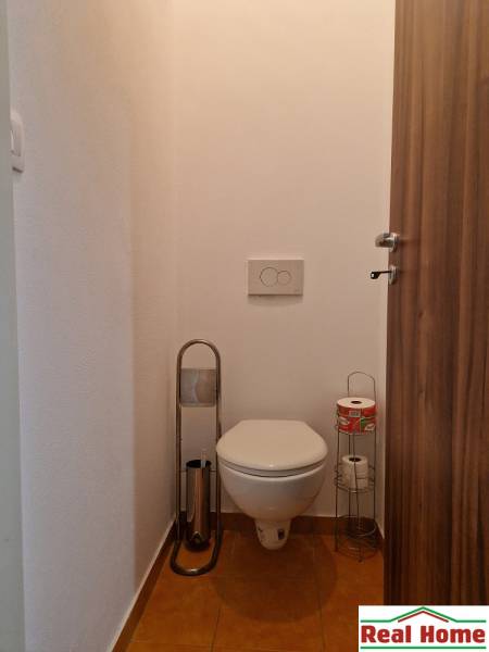 Bathroom with toilet and toilet paper holders in a studio apartment.