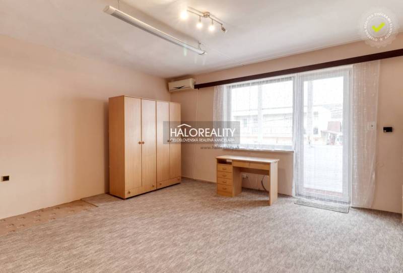 A bright room in a 3-room apartment with wooden furniture and a large window.