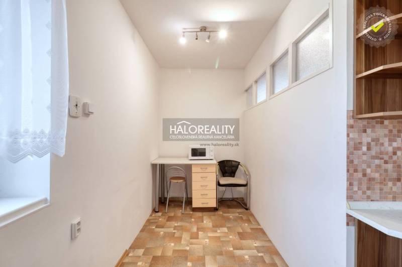 A cozy space with a microwave and a window in a 3-room apartment.