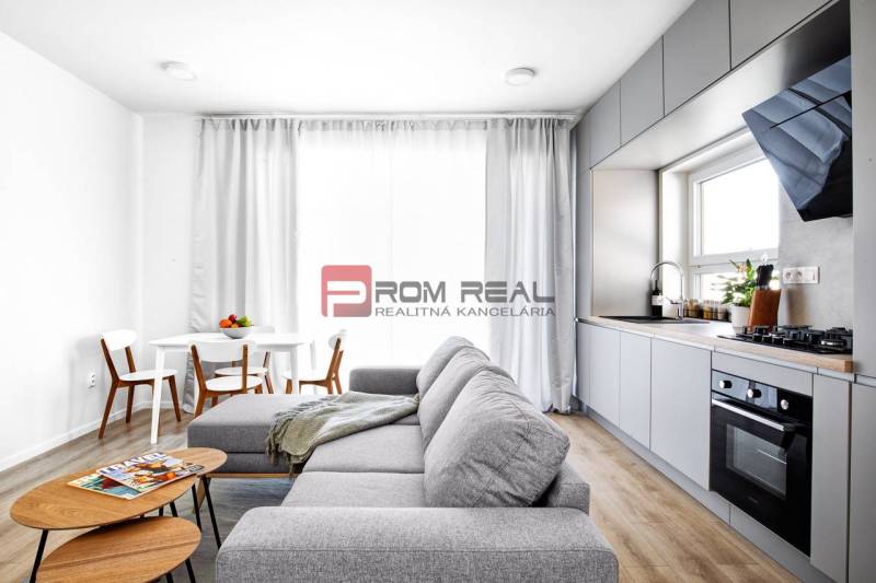 A bright space in a 3-room apartment with a kitchen unit and a dining area.